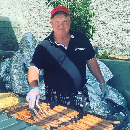 Great Aussie BBQ Catering Sydney featuring the boss Mal Ward on the tongs behind the BBQ